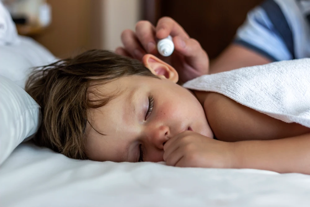 child getting ear drops to treat swimmer's ear
