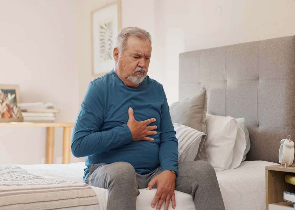 man experiencing acid reflux symptoms and in need of acid reflux treatment options