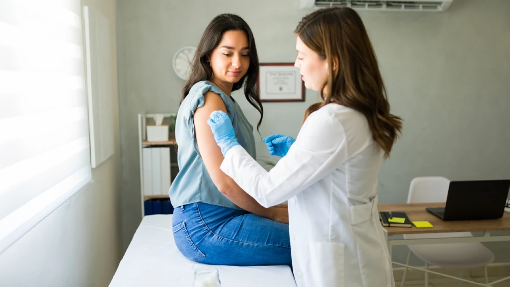 pharmacist administering a flu shot
