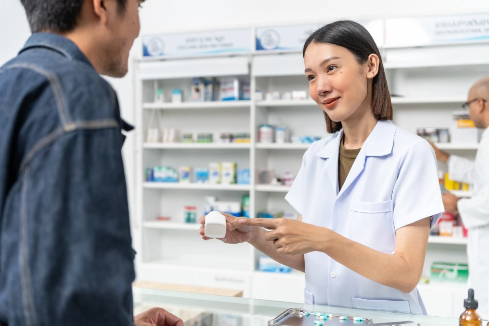 pharmacist showing a patient over-the-counter antacid treatment