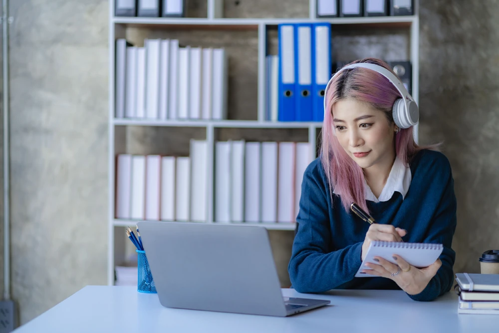 woman wearing noise-cancelling headphones to help with her adhd symptoms at work