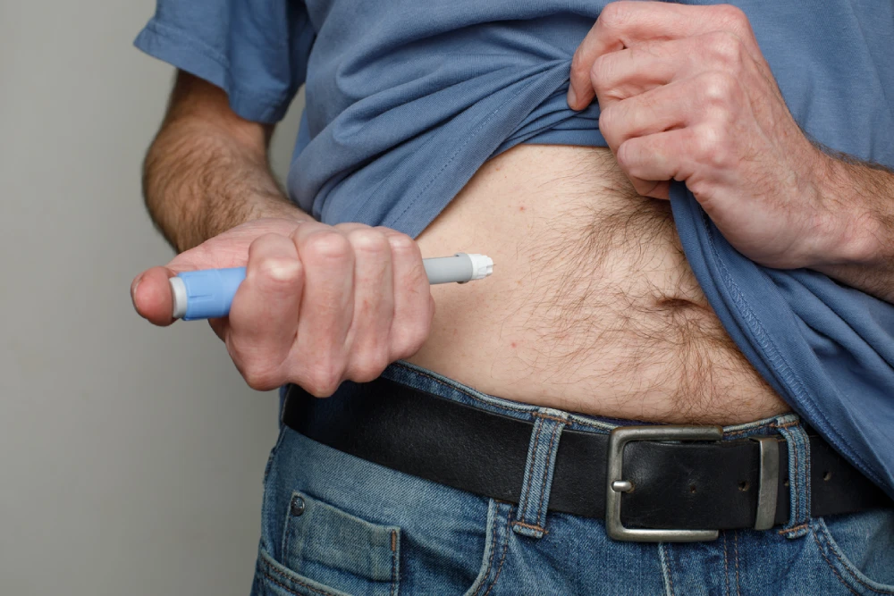 man using an Ozempic medical device