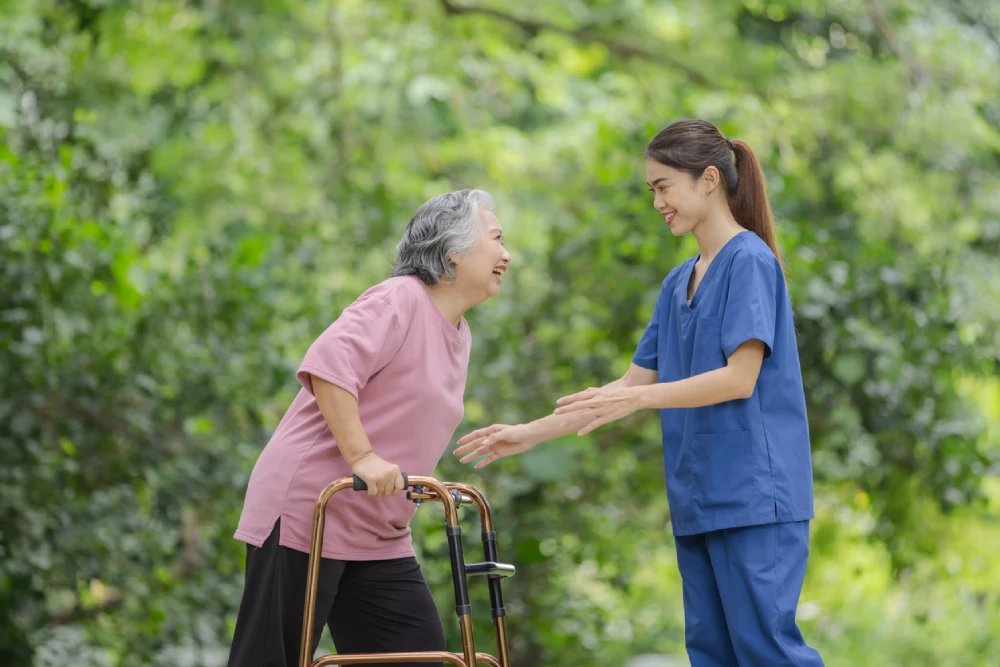 support worker walking with senior outside