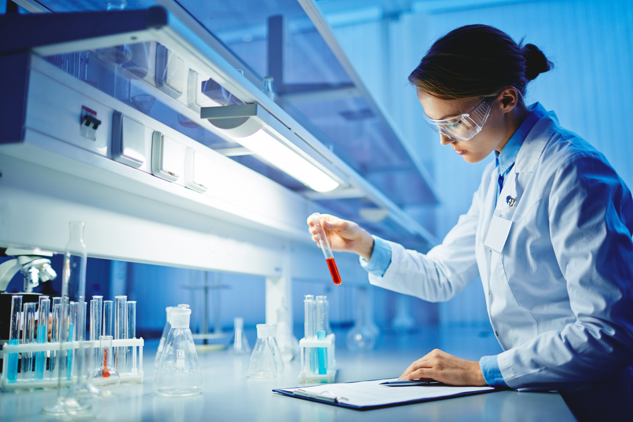 A young woman is testing substances in a lab.