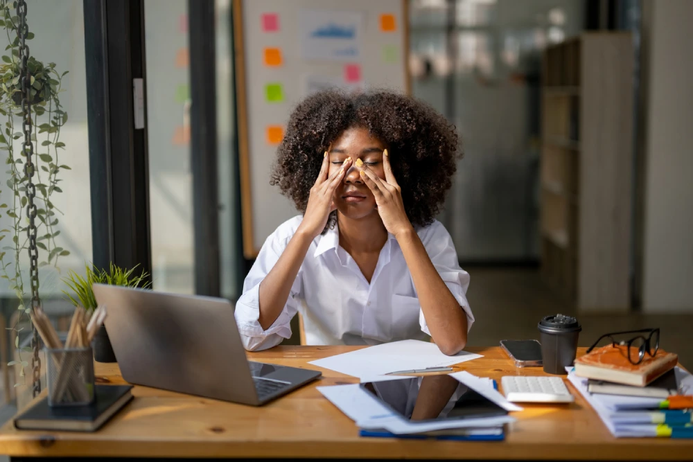 woman rubbing her face in frustration