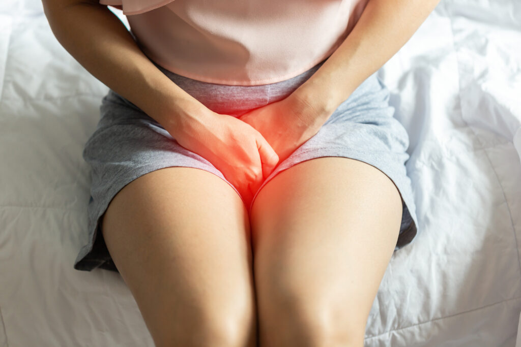 A woman suffering from a yeast infection turns away from her husband in their bedroom.