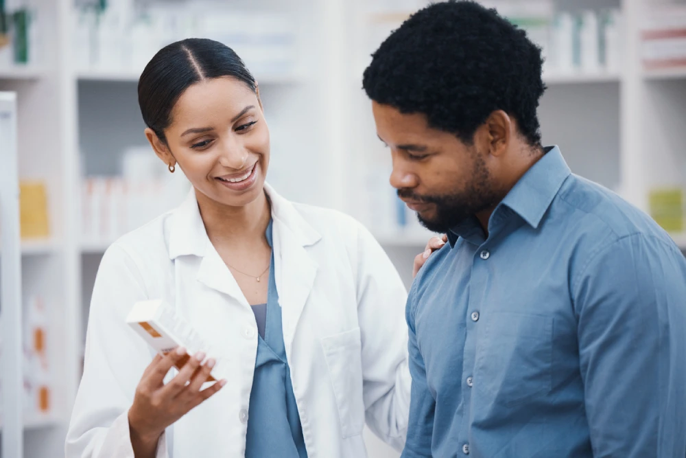 pharmacist showing a patient a product