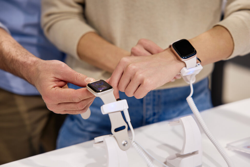 A young couple shops for smart watches.